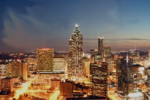 Photo of the Atlanta, Georgia downtown skyline at dusk, showing city lights.